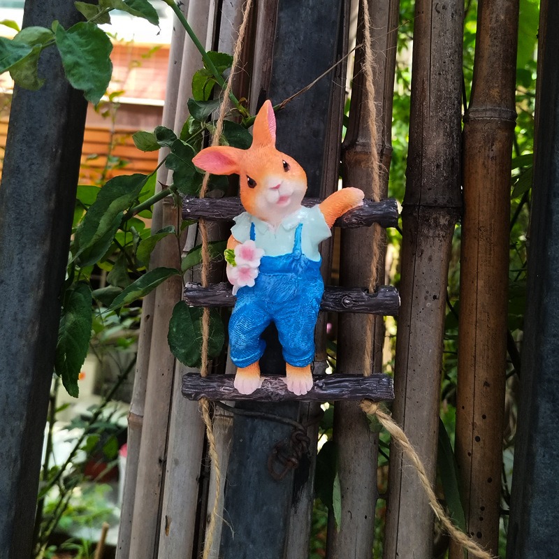 Rabbit ladder ornament hung in a garden setting with natural light
