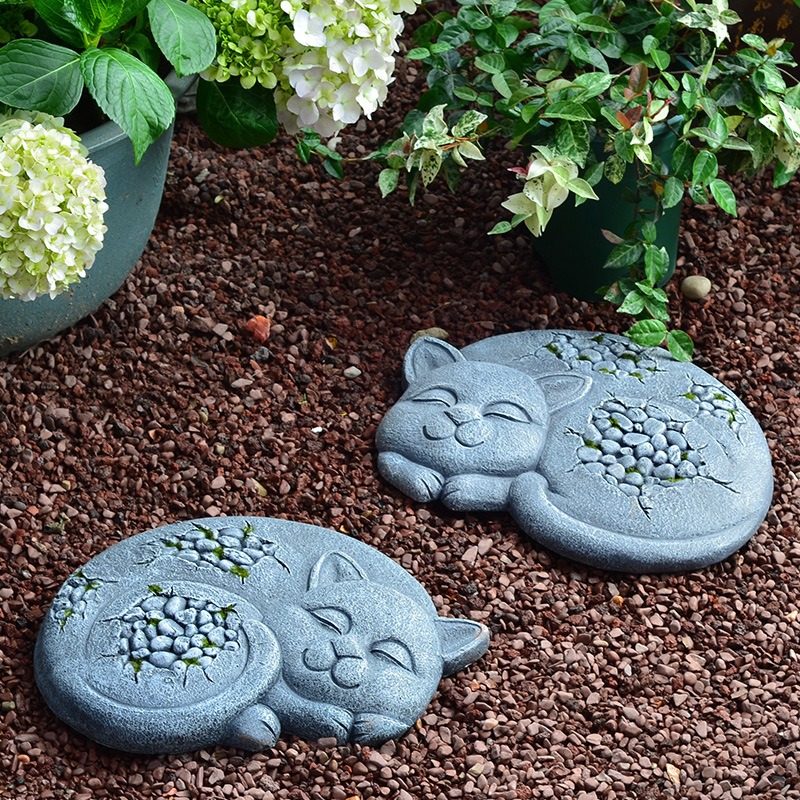 Garden path bordered by hydrangeas with stone set into mulch