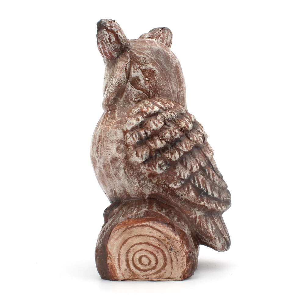 Back view of owl showing feather sculpting and tree-ring stump base