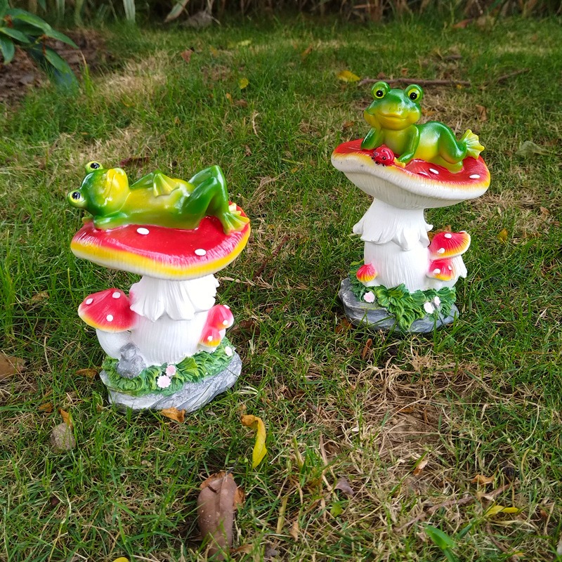 Frog figurine set among plants as a finished garden focal point