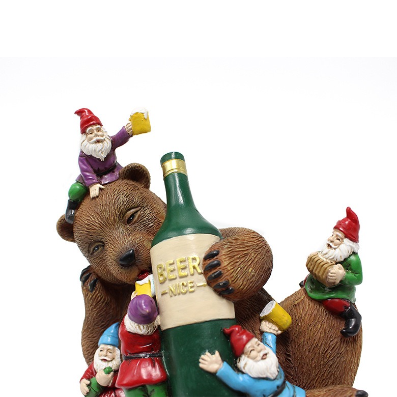 Close-up of bear face and gnomes holding mugs around the bottle