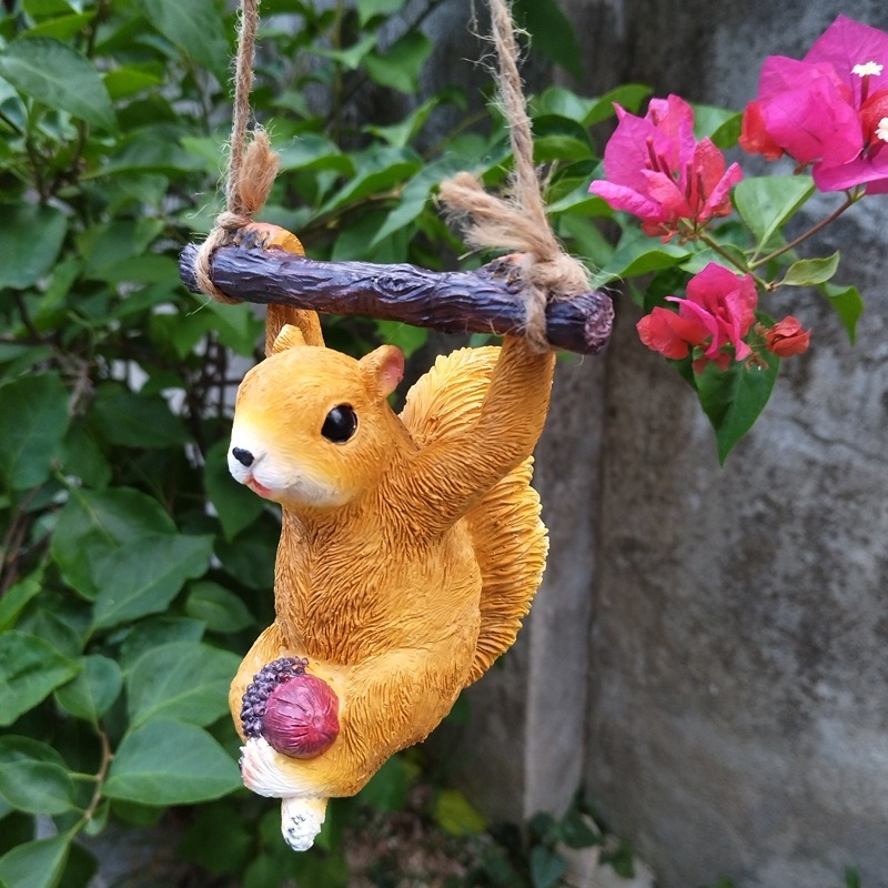 Hanging squirrel on a patio branch catching the afternoon light