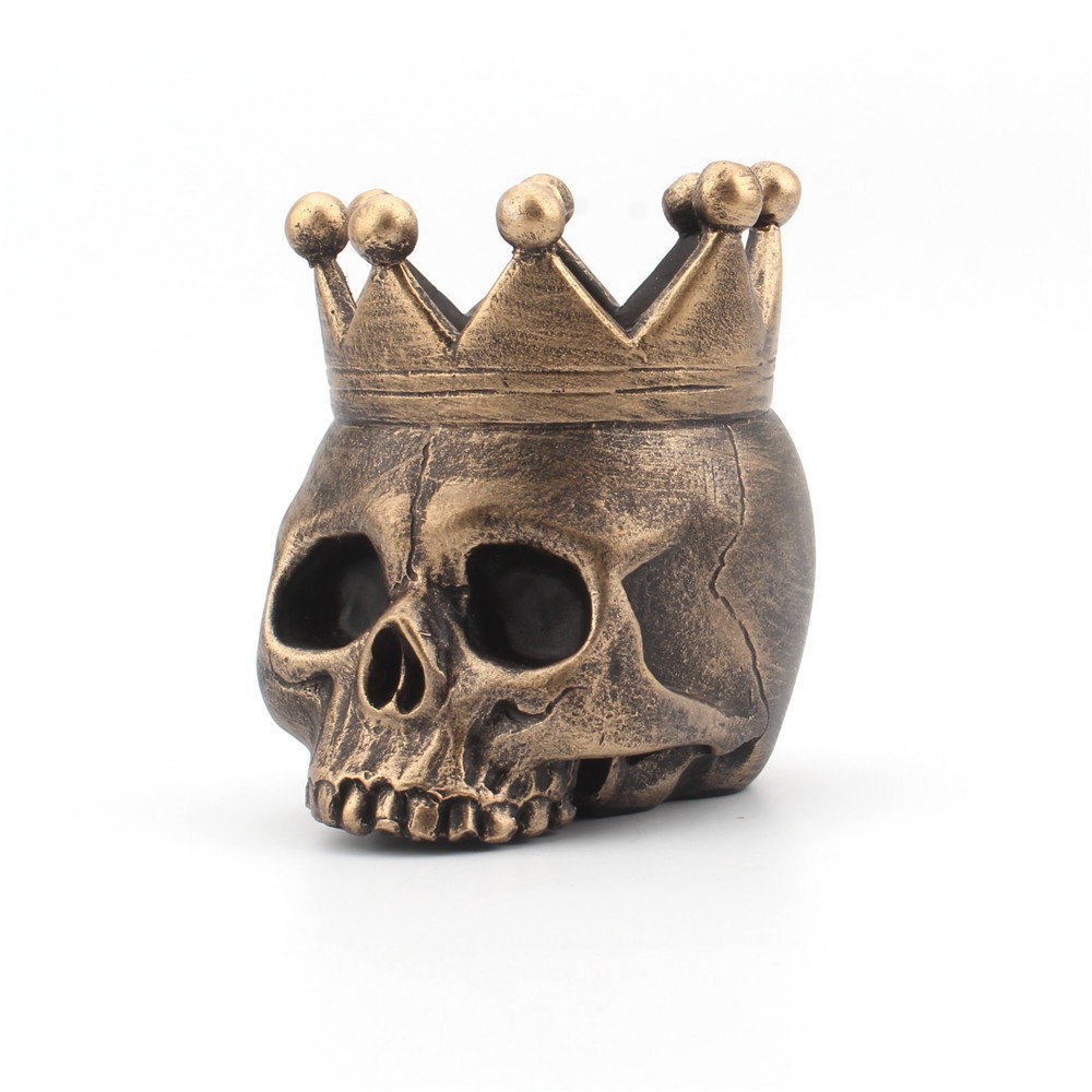 Black skull crown candle holder with a tealight glowing inside