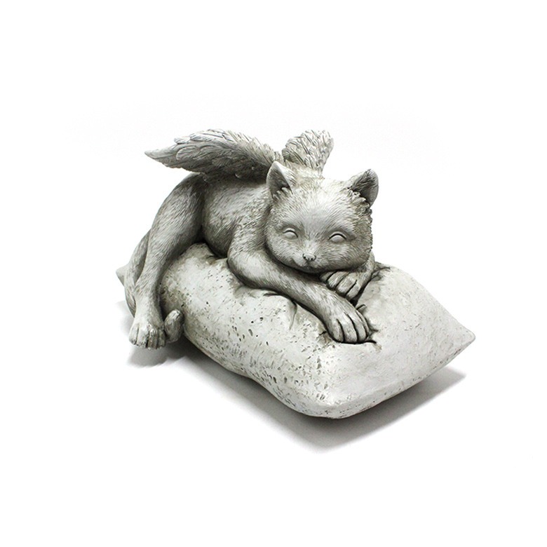 Grey resin angel cat statue on pillow base seen from a low front angle