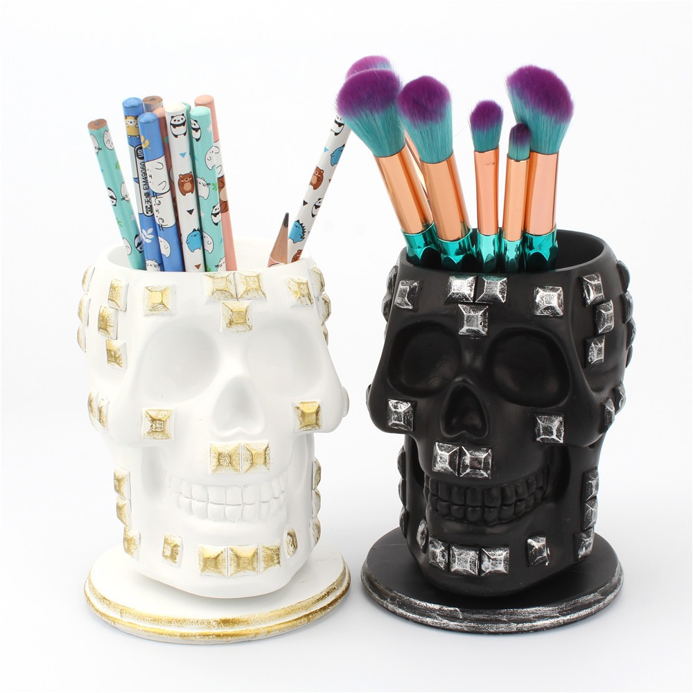 Skull brush holder with rose gold brushes styled in a dark room setting