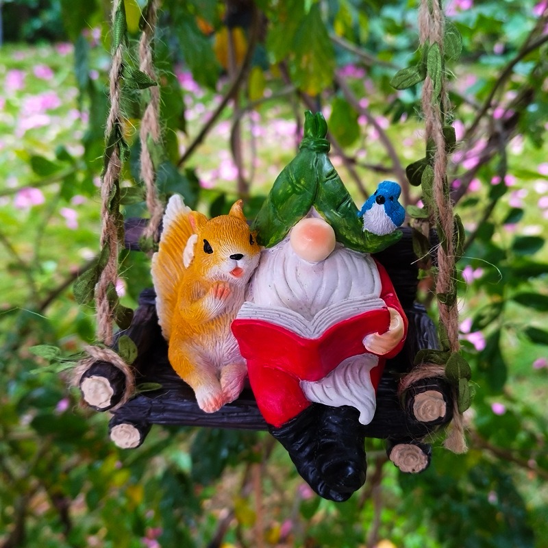 Reading gnome and squirrel figurine resting on a rustic log bench