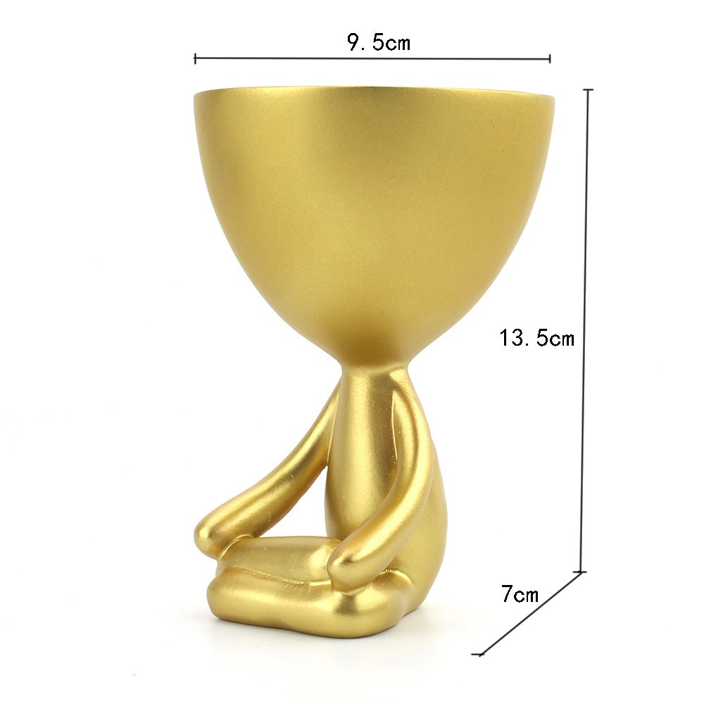 Gold figurine planter with dimension lines on a plain light background