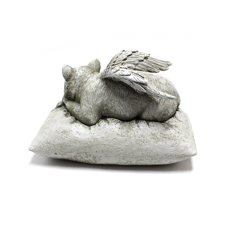 Side profile of sleeping angel cat with wing extended over the pillow