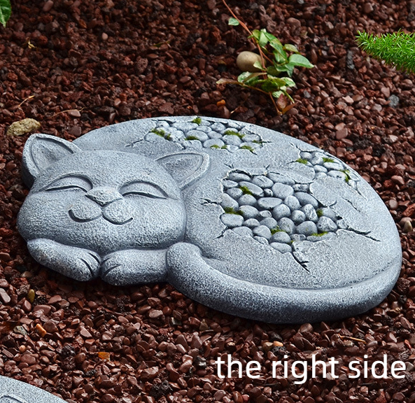Right-side profile of a sleeping cat stepping stone in a mulch bed