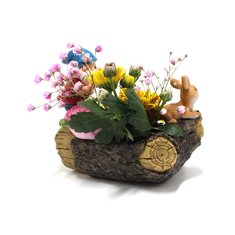 Log planter filled with pink and yellow flowers, side angle view