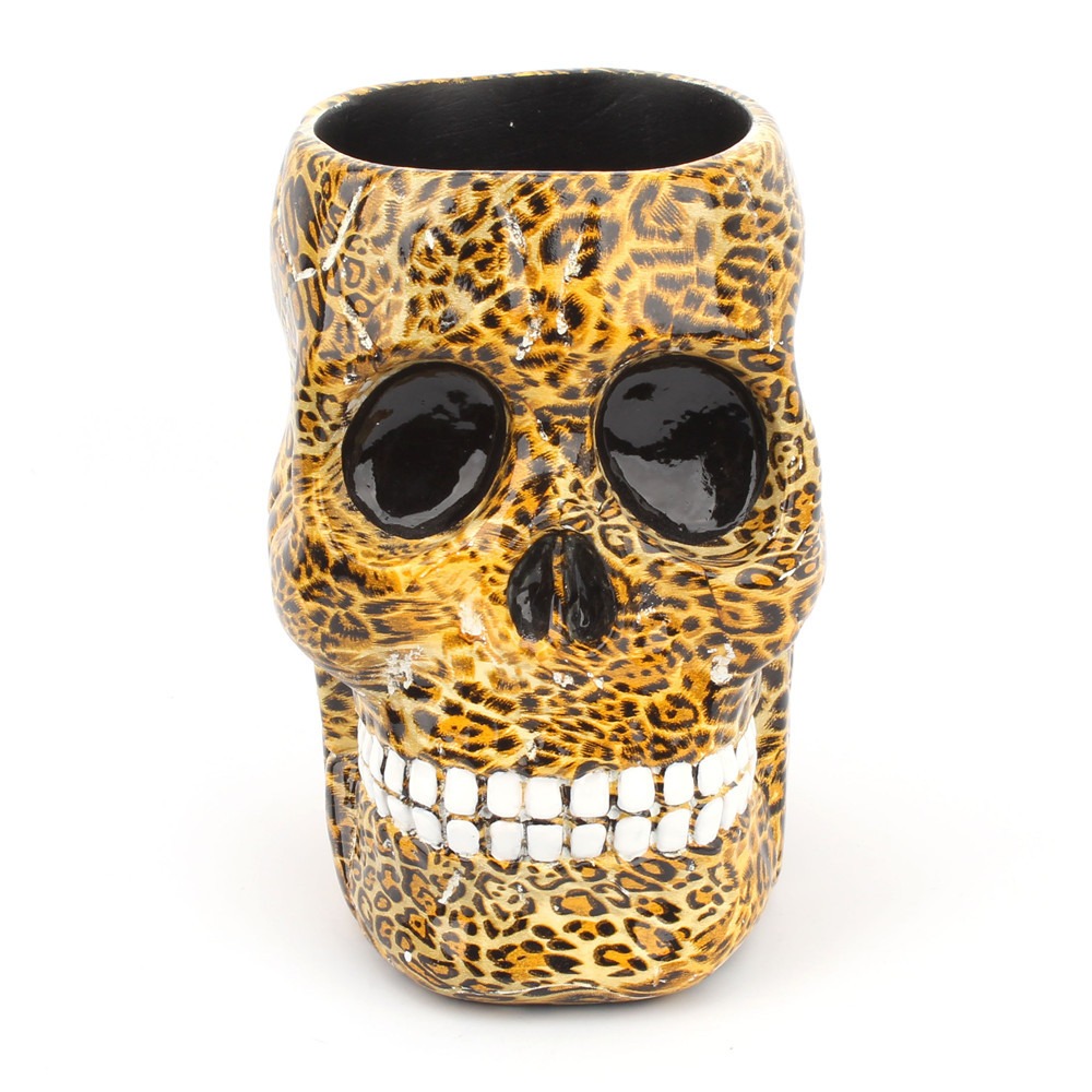 Leopard-print skull desk holder front view with glossy black eye sockets