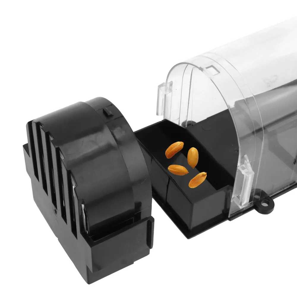 Close-up of the black back door cap and the bait tank holding orange grain seeds