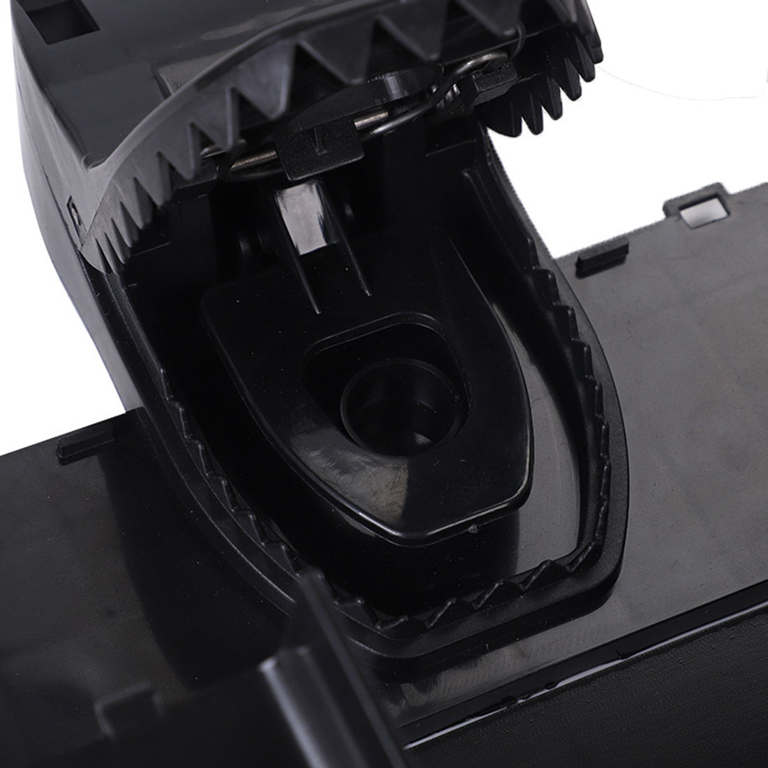 Recessed bait cup and spring-loaded jaw inside the trap housing