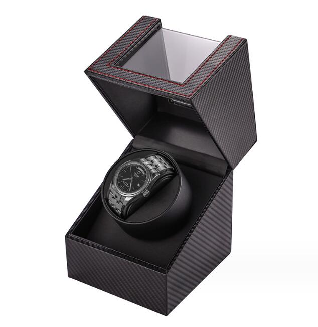 Carbon fiber watch winder with lid open, watch running in its cradle