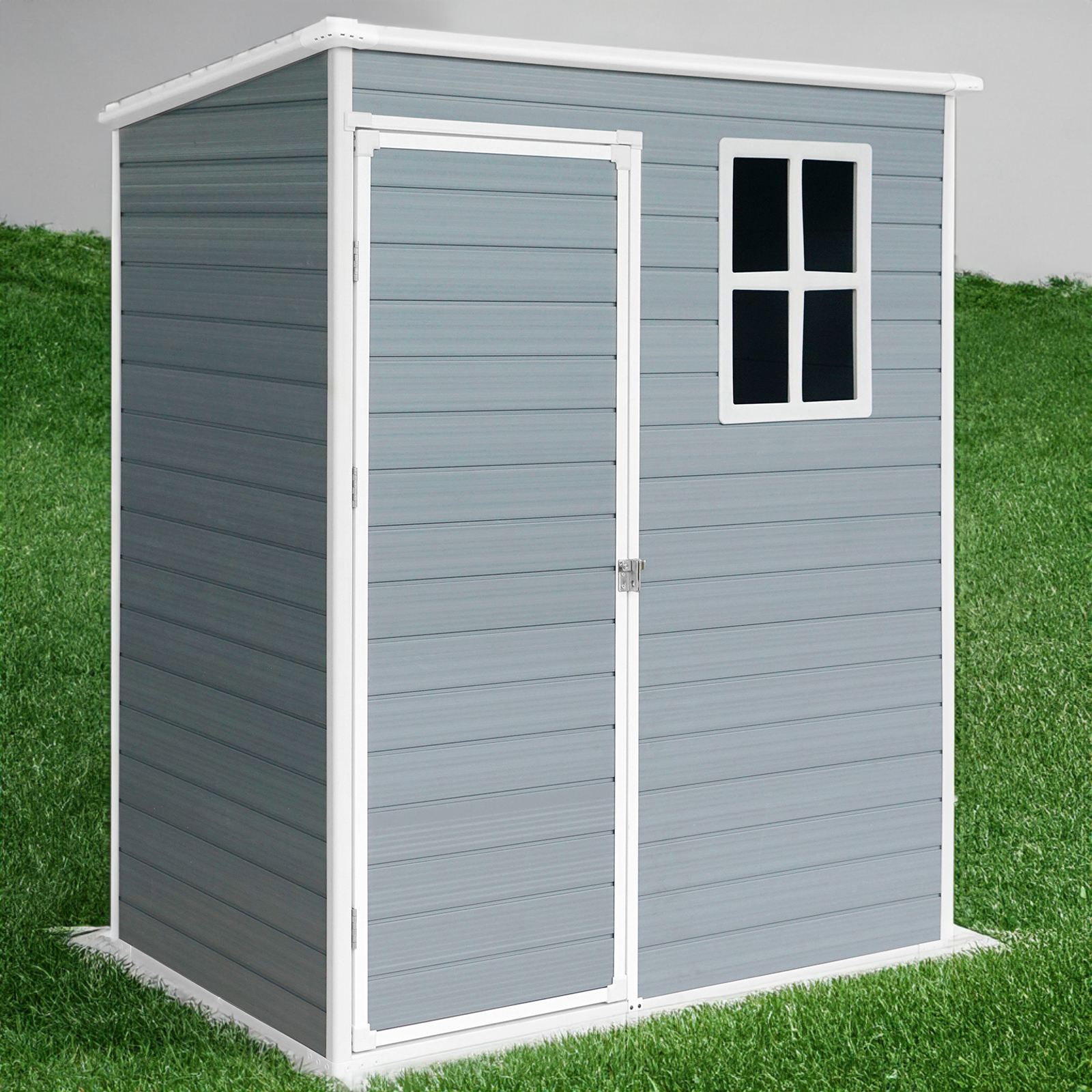 Grey resin shed standing on a green lawn beside outdoor garden space