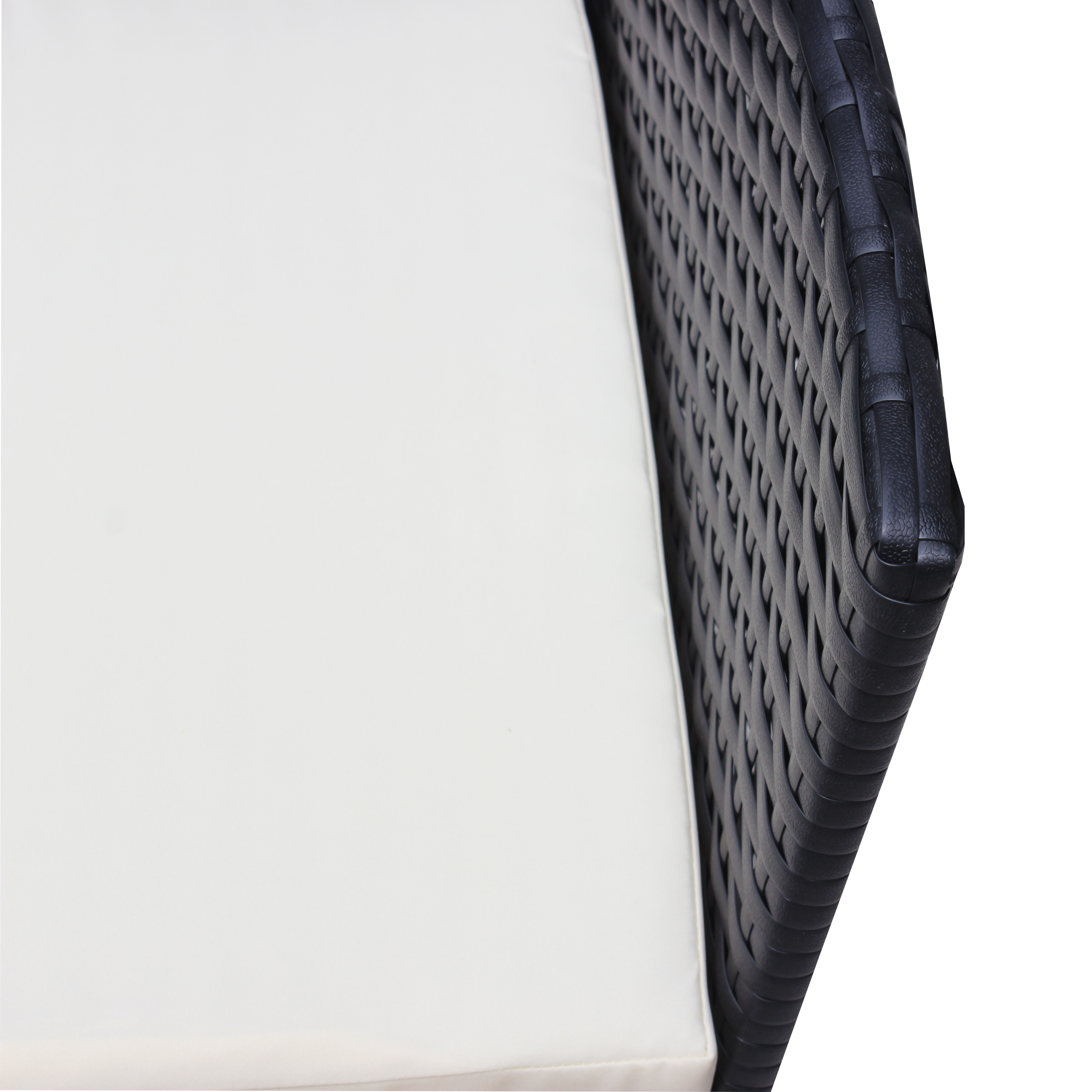 Cream cushion beside woven black rattan armrest