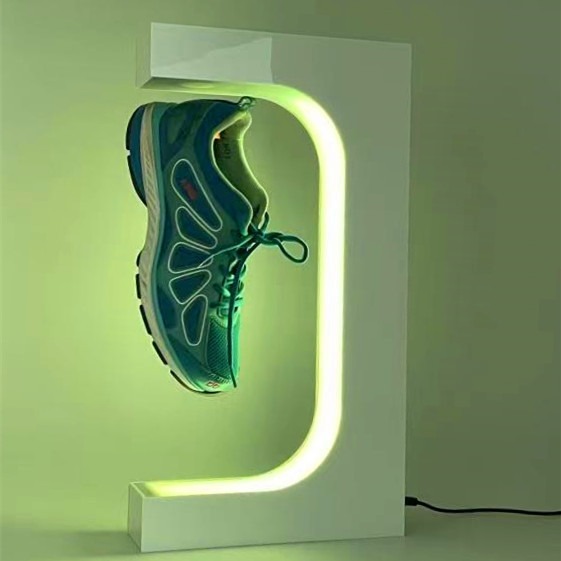 Sneaker lifted inside a lit acrylic frame as a focal point