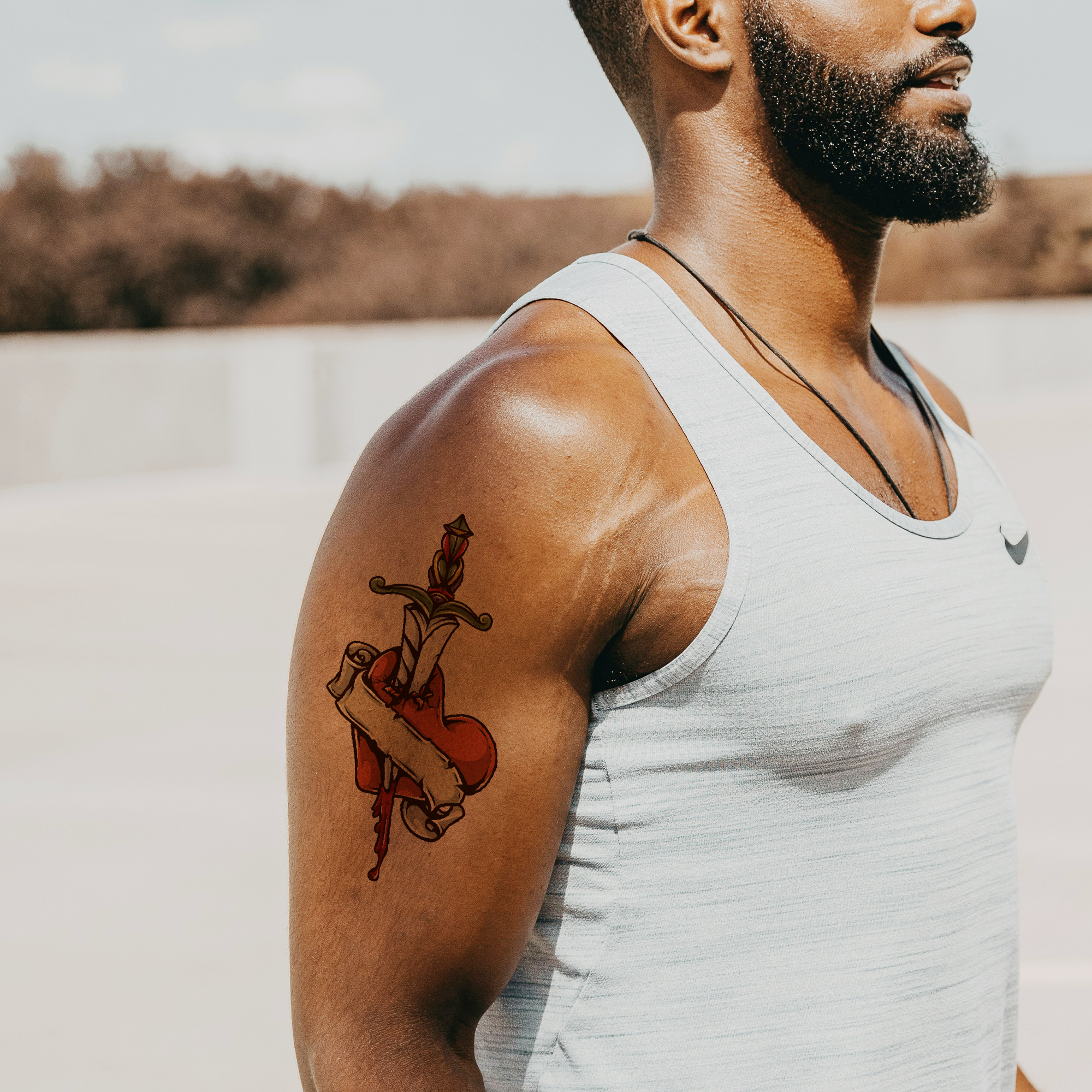 Temporary tattoo heart and cross design on man's arm, perfect for events
