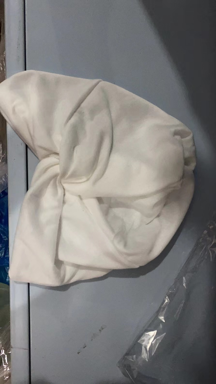Cream elastic turban showing flexible gathered construction