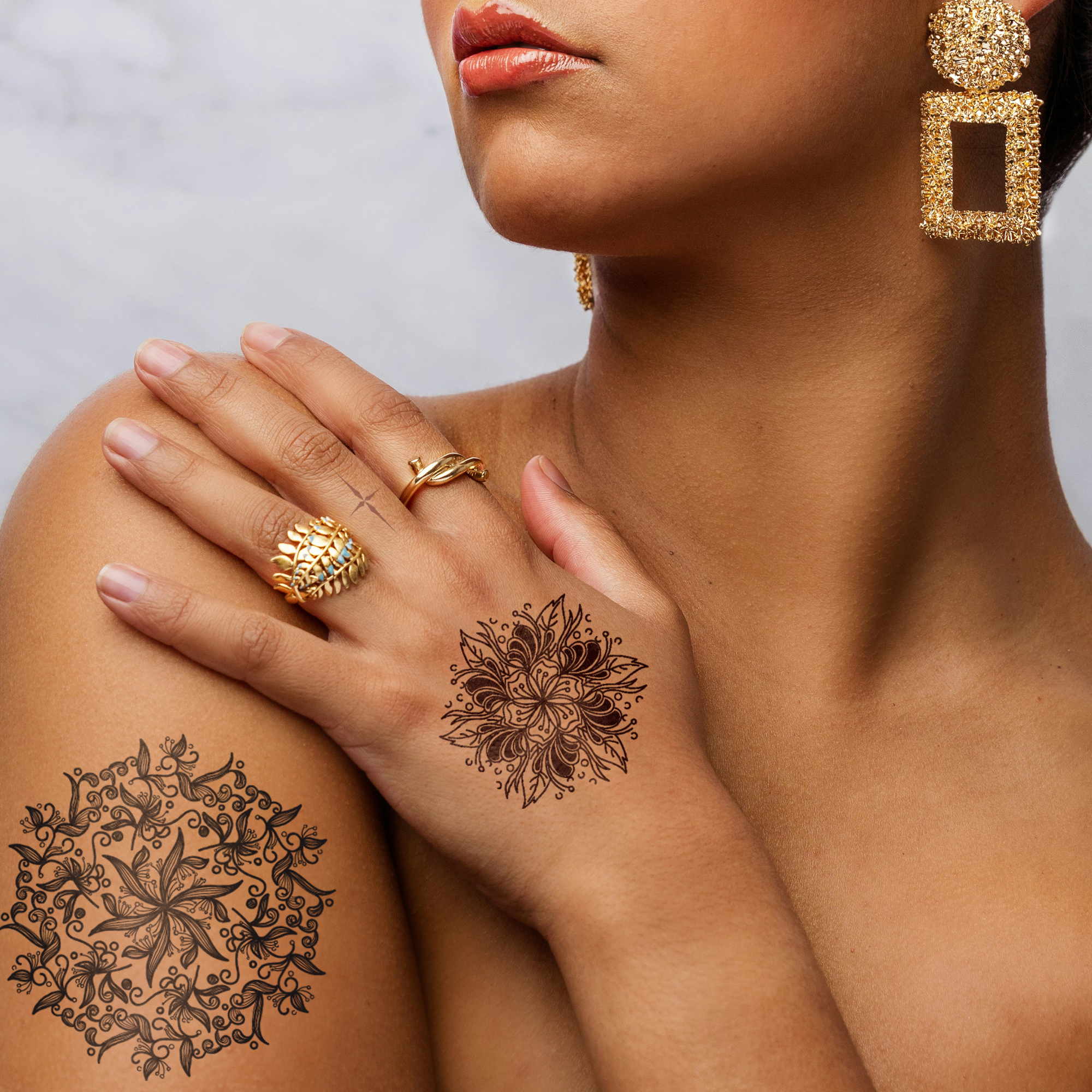 Woman with mandala temporary tattoos on shoulder and hand, perfect for fashion events