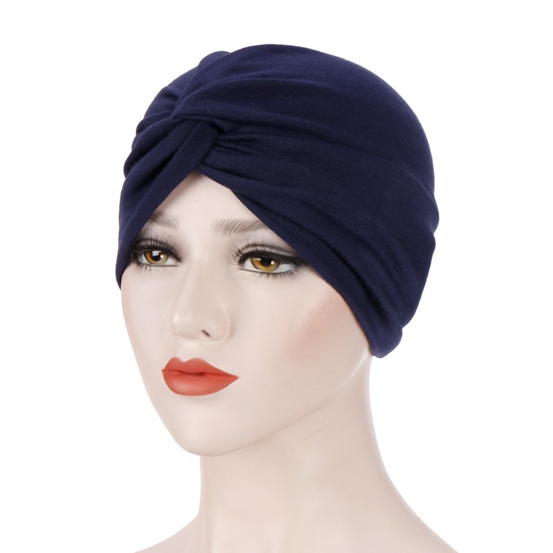 Navy turban showing gathered volume and close fit
