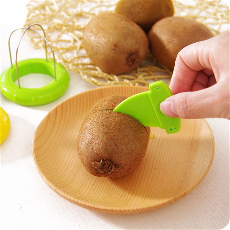 Hand peeling a whole kiwi on a wooden plate with a serrated tool