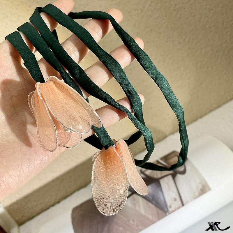 Peach tulip hair loop showing translucent mesh petals