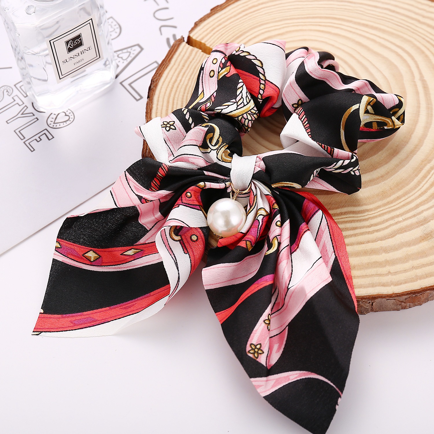 Gathered elastic loop attached to decorative bow