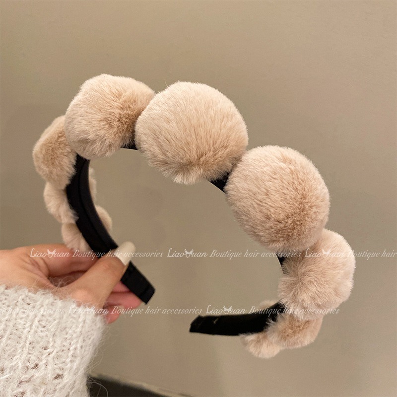 Plush headband held to show wearable curved shape