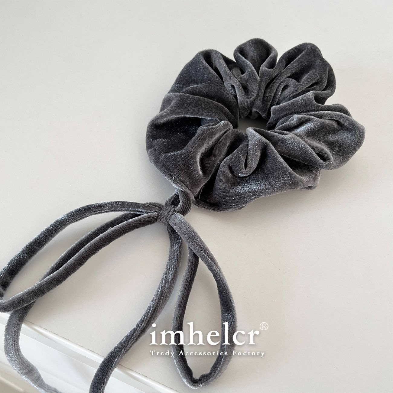 Close view of charcoal velvet folds and plush matte texture