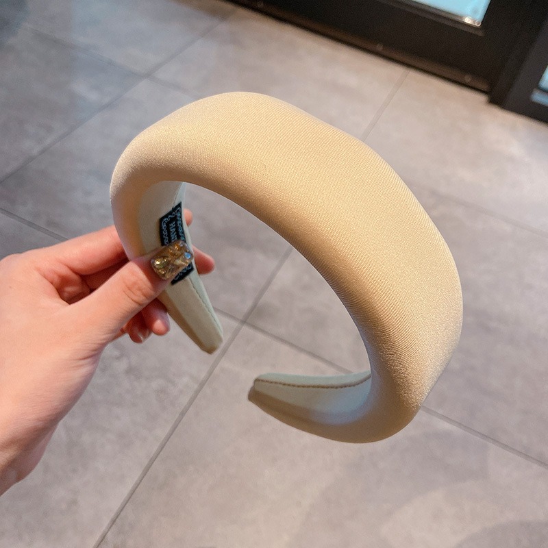 Cream headband showing open-ended rounded frame