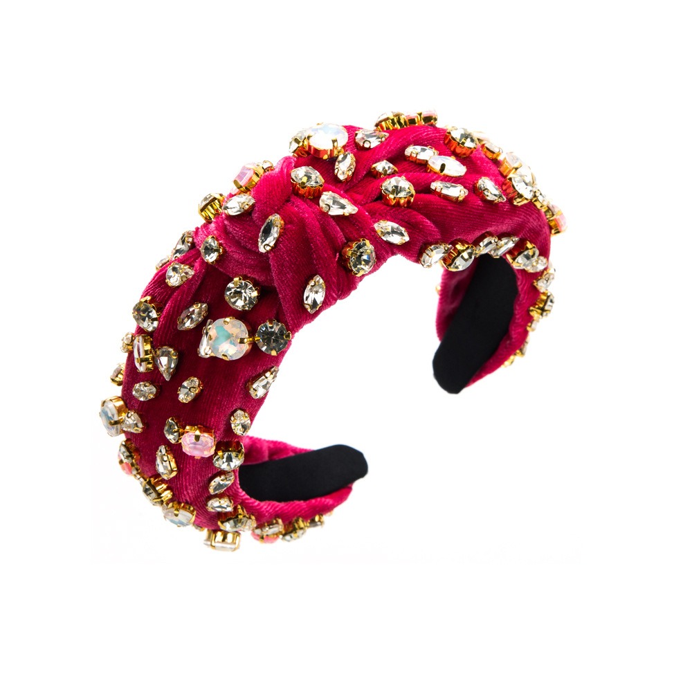 Magenta padded headband showing ornate rhinestone settings
