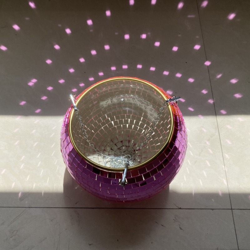 Mirror tile planter throwing pink light dots across a wall