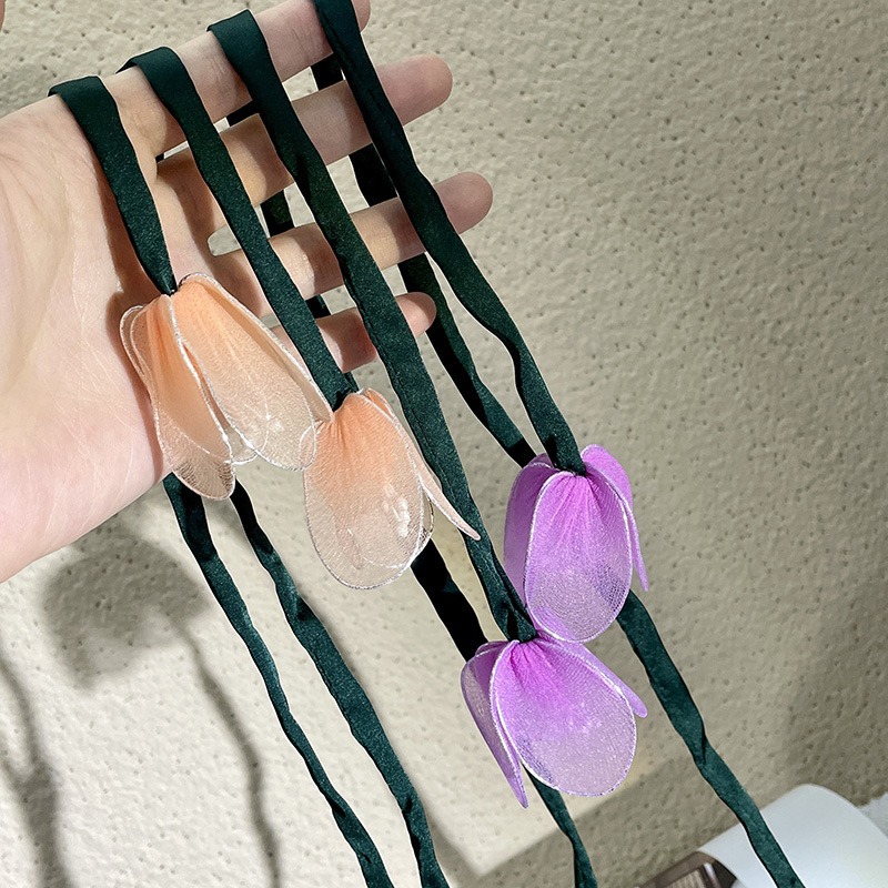 Purple and peach floral loops with long green ribbons