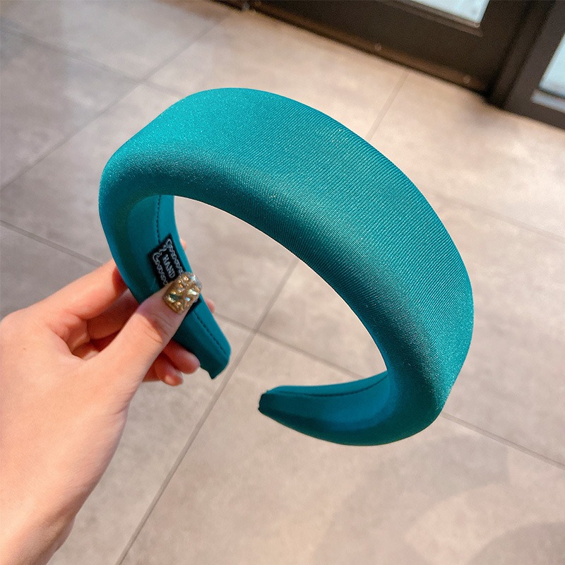 Teal padded headband showing bold solid color