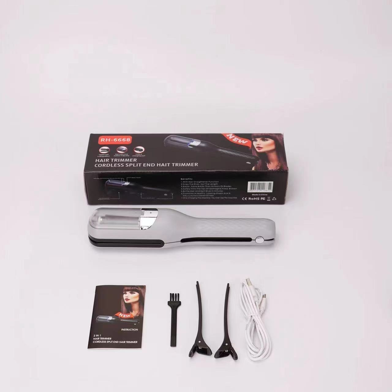 Matte silver trimmer beside its box, comb, clips and cable