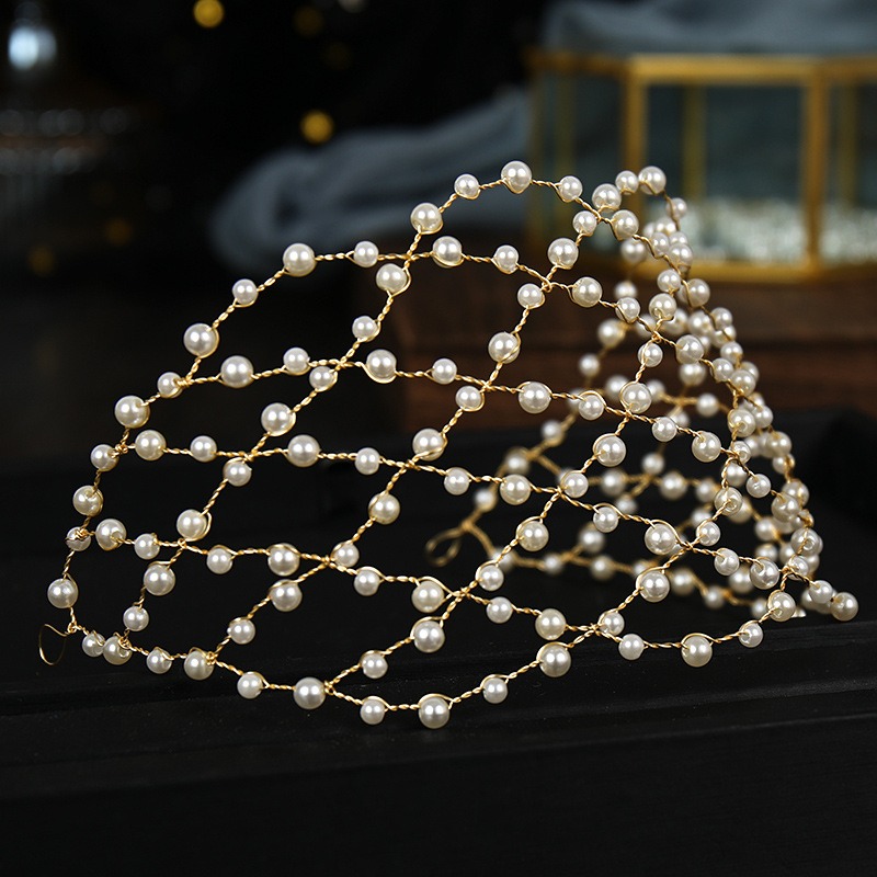 Glossy ivory pearls arranged across a formal hair accessory