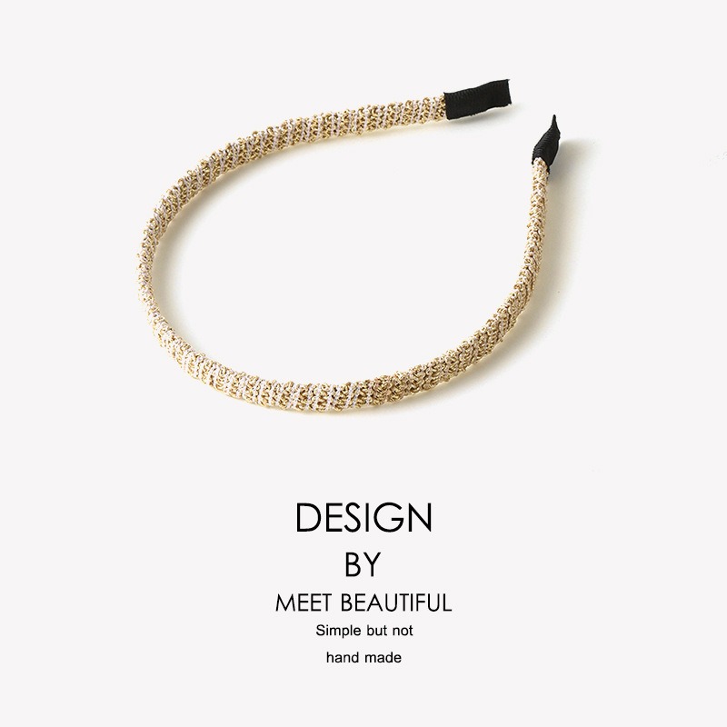 Gold textured hair clip with black end caps