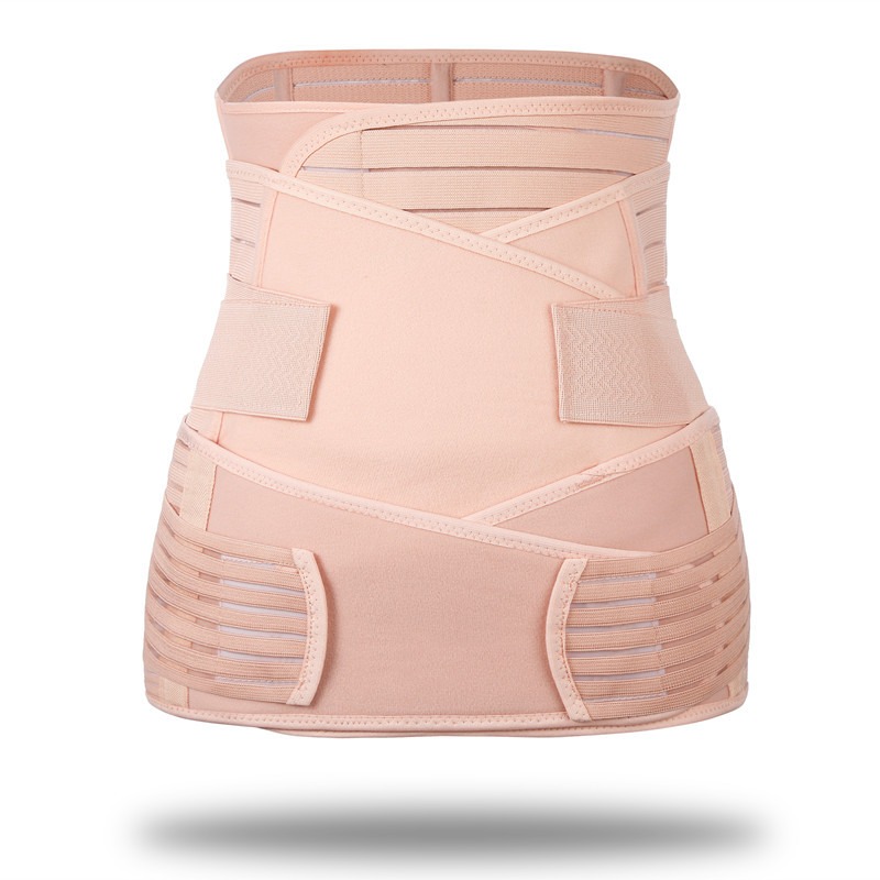 Complete three-piece postpartum support strap set displayed flat against ivory ribbed glass surface