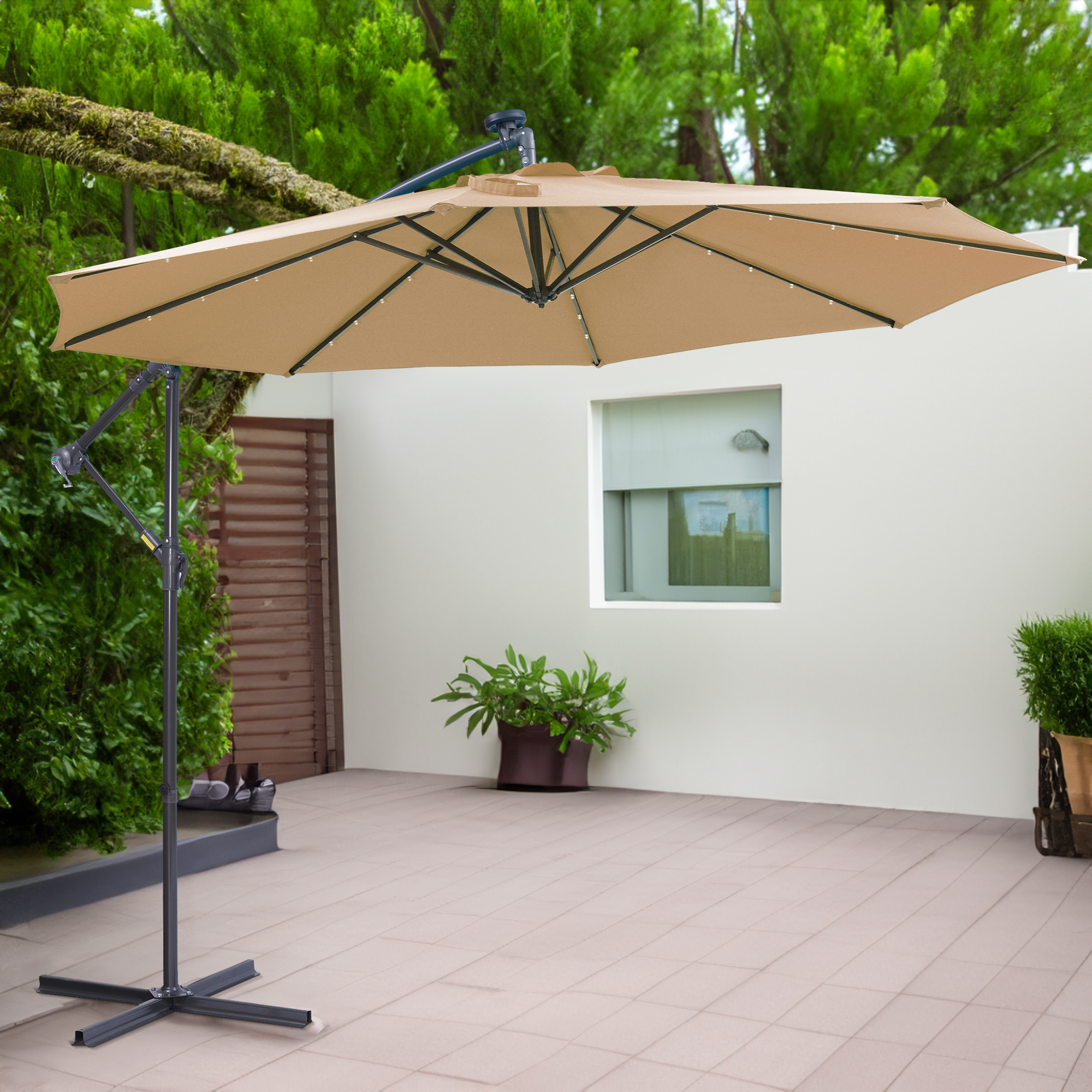 Taupe 10 ft cantilever umbrella over a tiled patio beside a planter