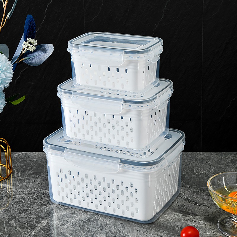 Three stacked clear produce containers on a marble counter