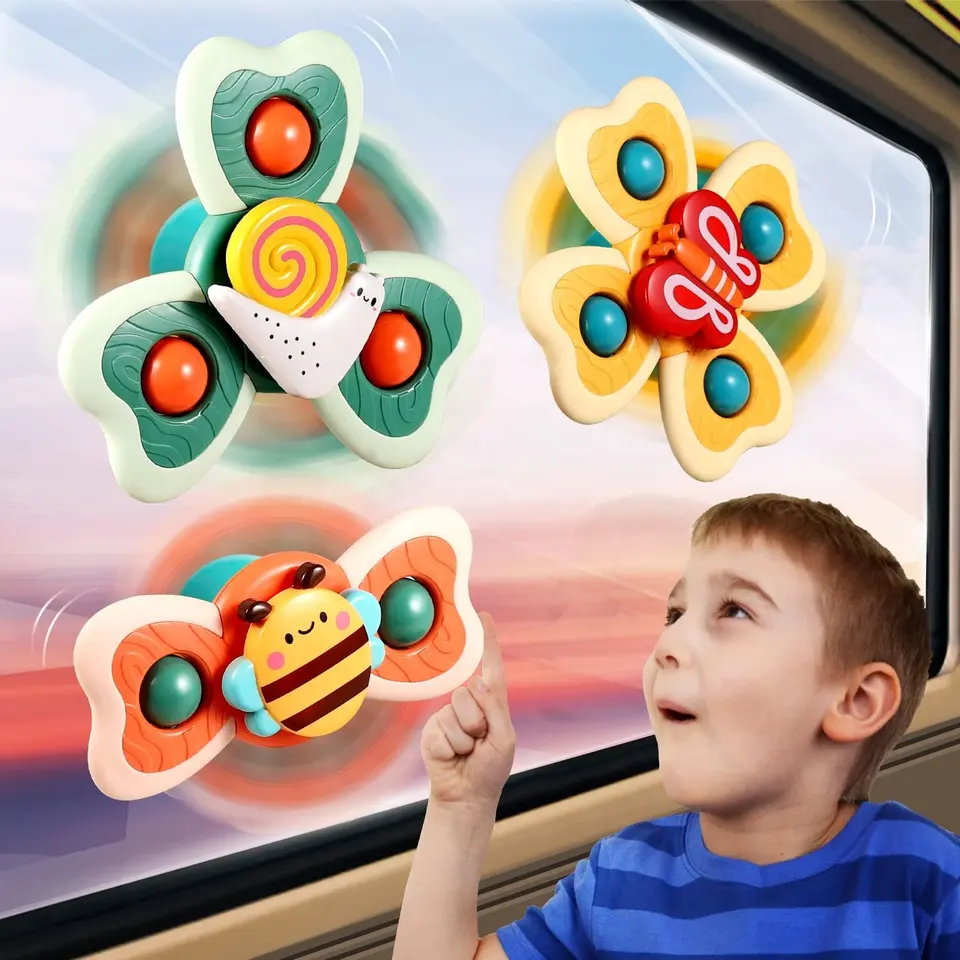 Child spinning insect toys attached to car window