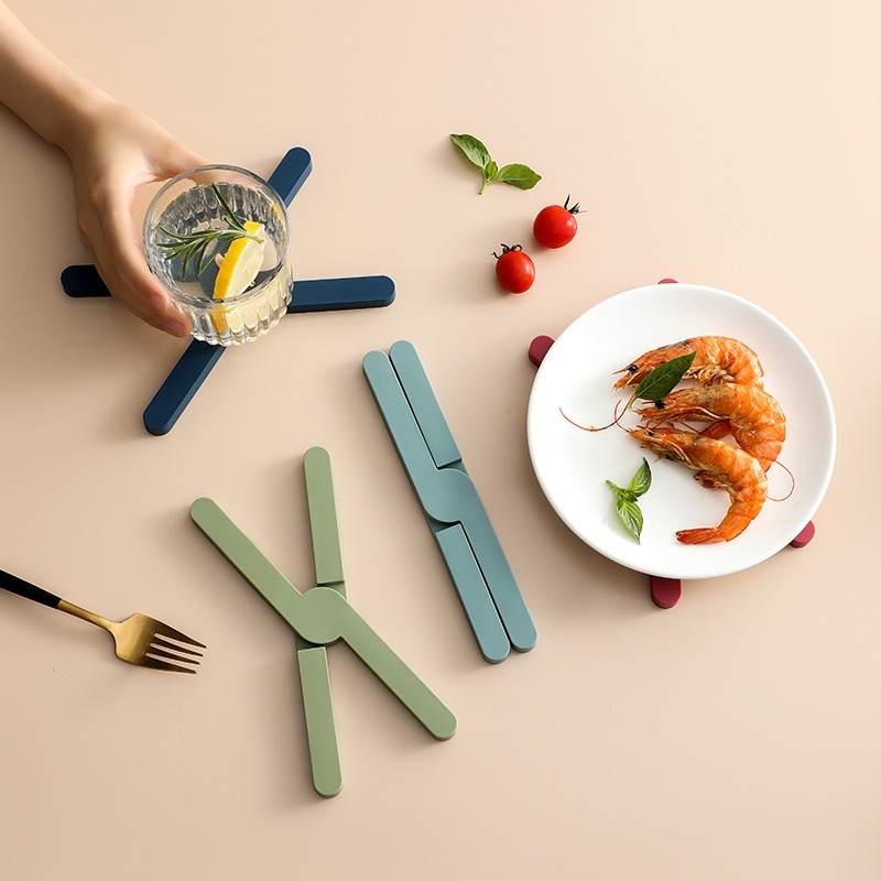 Teal X-shaped trivet supporting plate and drinkware
