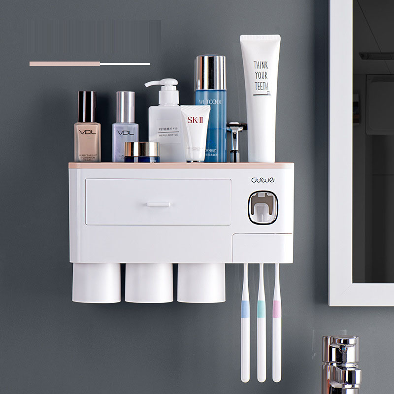 Compact wall organizer with pink shelf and toothpaste dispenser