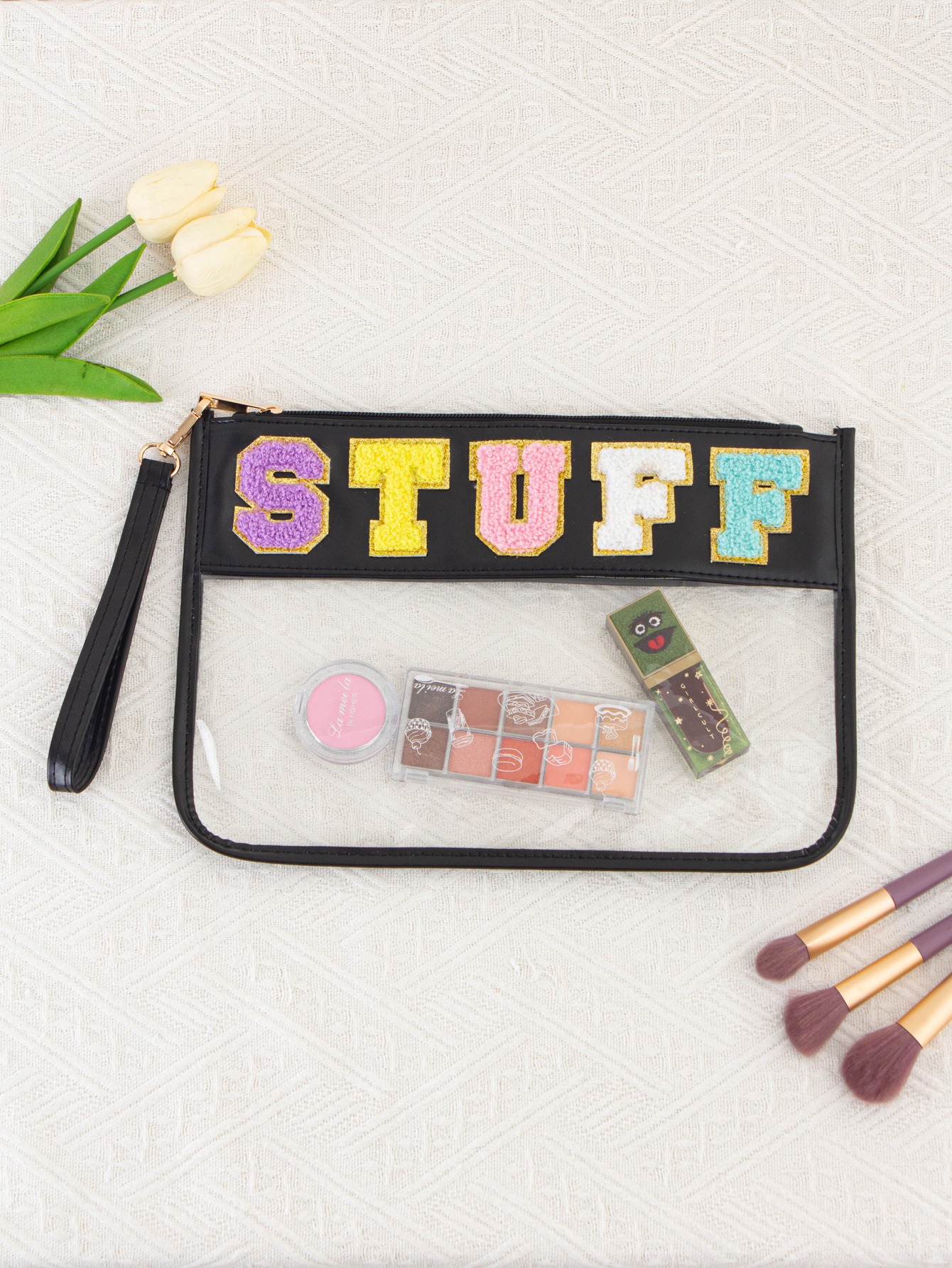 Black clear zip pouch with chenille letters, gold zip pull and wrist strap
