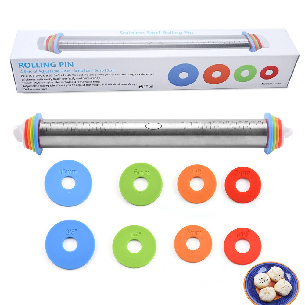 Rolling pin beside pastry mat with red dough guides