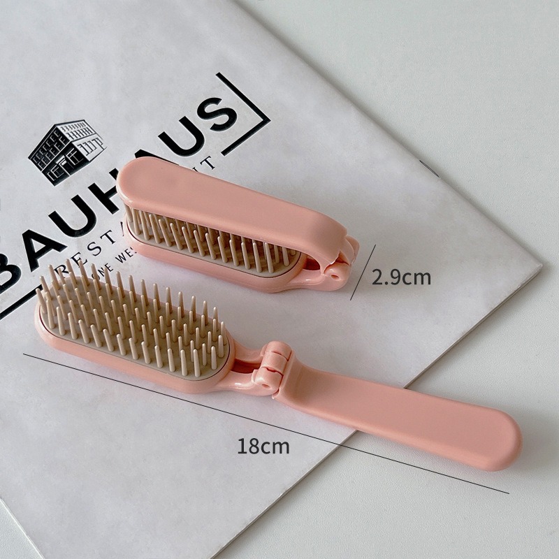 Pink comb open and folded with compact dimensions shown