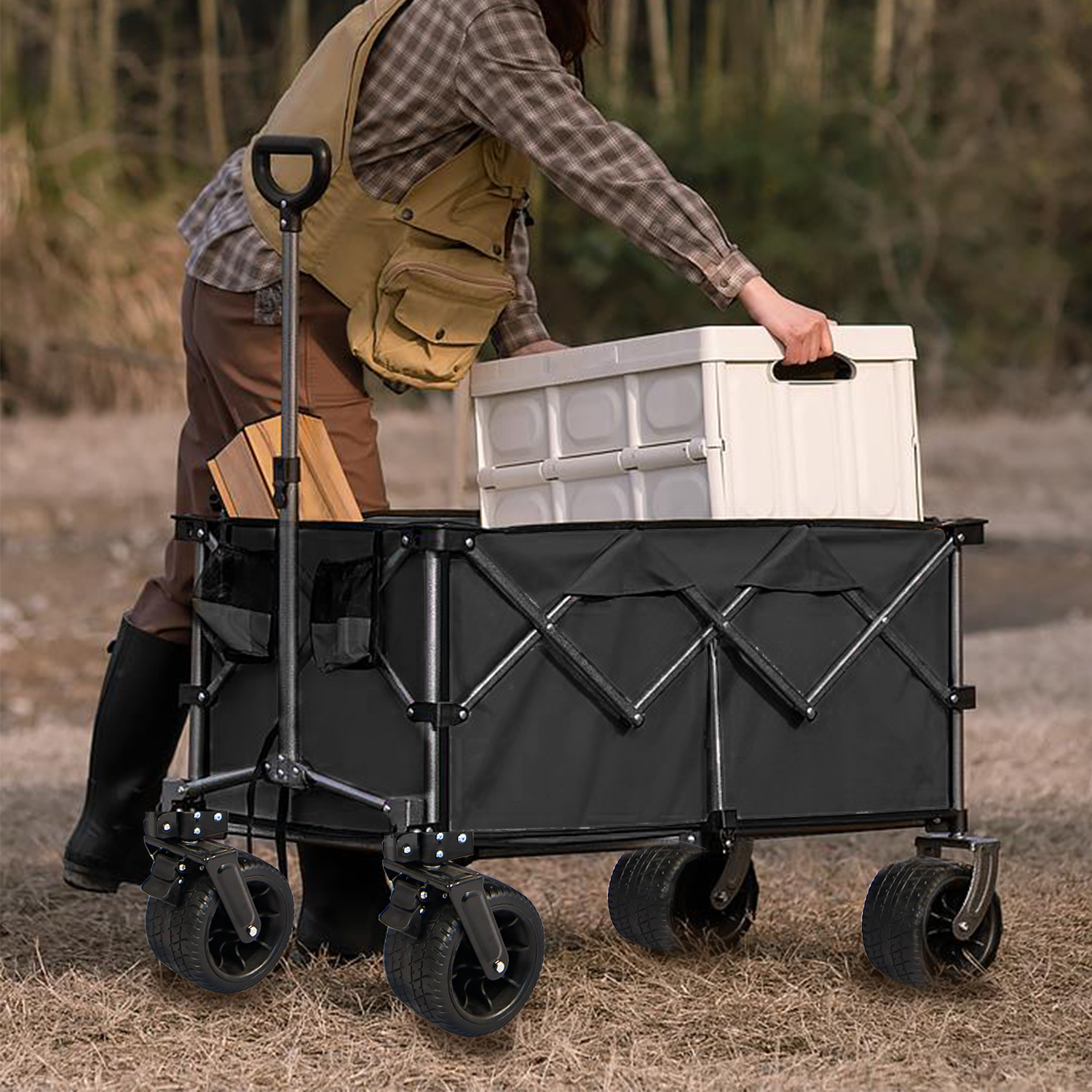 Wagon loaded with cooler and chairs rolling across grass toward camp