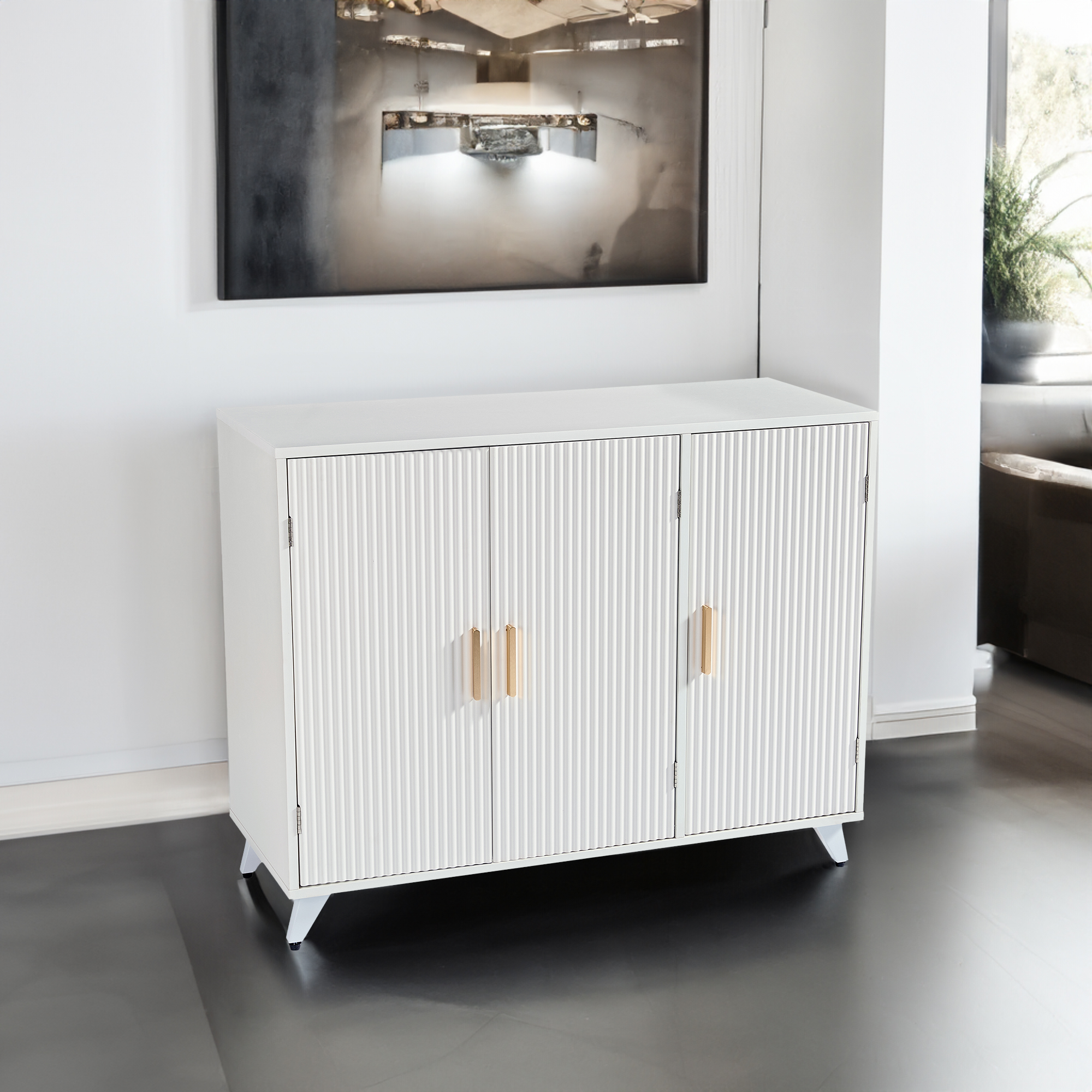 White fluted sideboard styled in a bright living room beside framed art