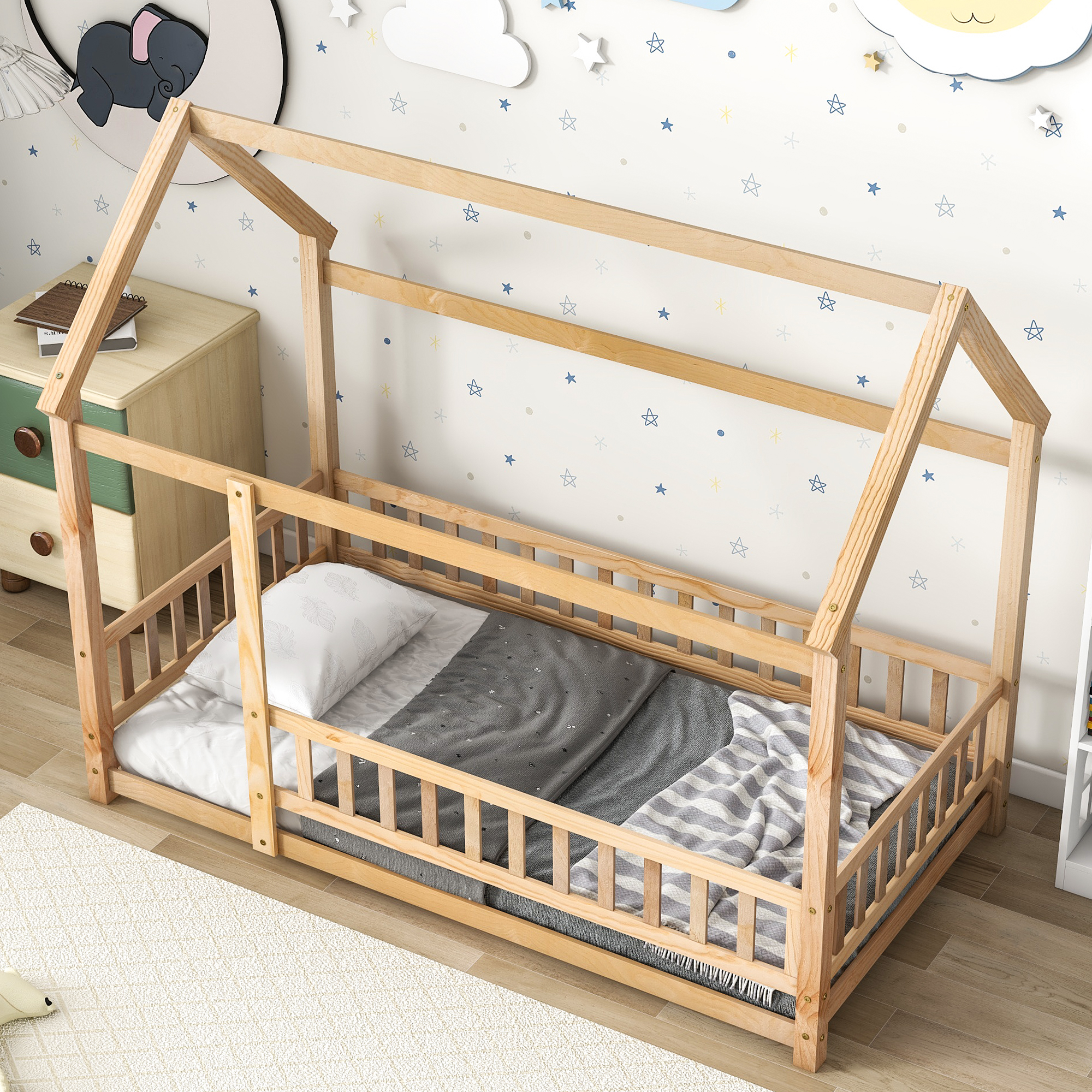 House bed with pillow and gray bedding in a star-printed kids room
